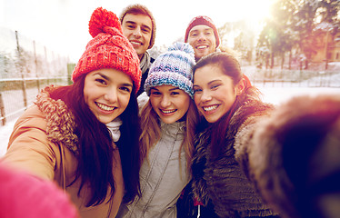 Image showing happy friends taking selfie with smartphone