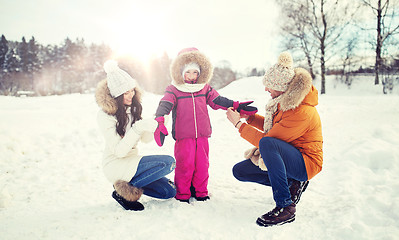 Image showing happy family with child in winter clothes outdoors