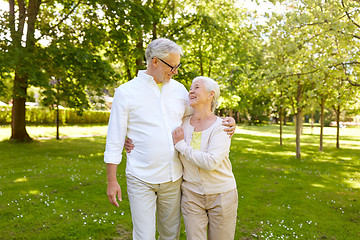 Image showing happy senior couple hugging in city park