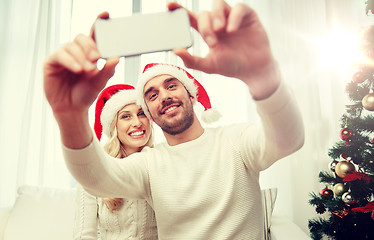 Image showing couple taking selfie with smartphone at christmas