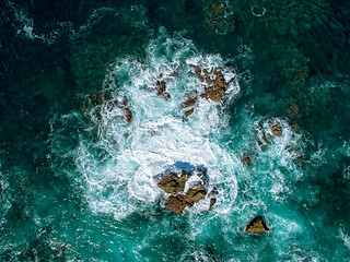 Image showing Aerial View of Waves Breaking on Rock