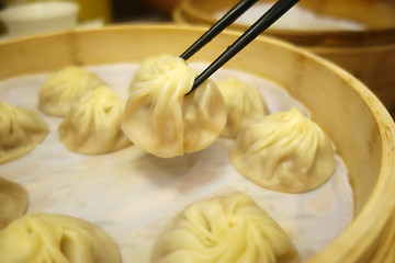 Image showing Xiao Long Bao with chopsticks Streamed Pork Dumplings Taiwan foo