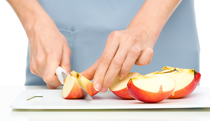 Image showing Cook is chopping apple