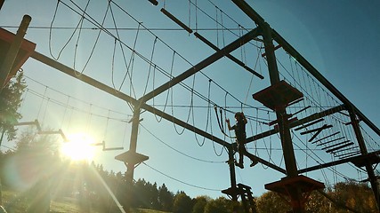 Image showing Unidentifiable boy climbing in high rope park