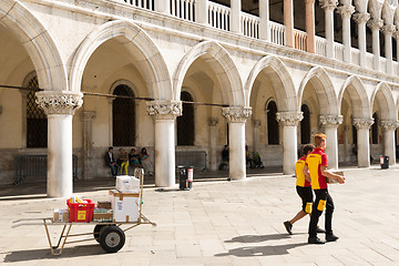 Image showing DHL Postmen delivering parcels on the Piazza San Marco in Venice