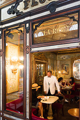 Image showing Asian tourists sitting in a cafe at the Piazza San Marco in Venice, Italy.