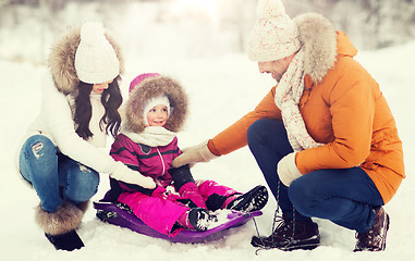 Image showing happy family with sled walking in winter forest