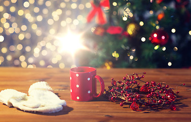 Image showing tea cup with mittens and christmas decoration