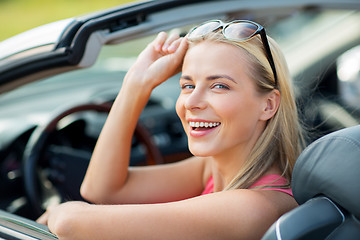 Image showing happy young woman in convertible car