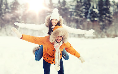 Image showing happy couple having fun over winter background