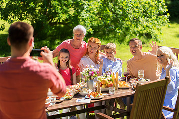 Image showing happy family photographing by smartphone in summer