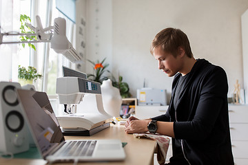 Image showing fashion designer with making dress at studio