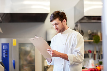 Image showing chef with clipboard doing inventory at restaurant