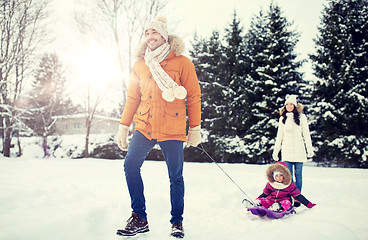 Image showing happy family with sled walking in winter outdoors