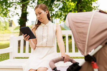 Image showing happy mother with tablet pc and stroller at park