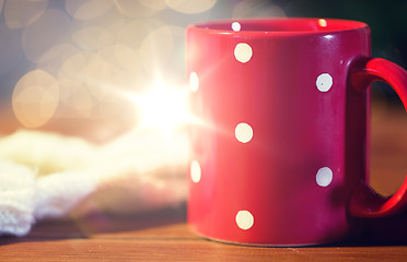 Image showing red polka dot tea cup on wooden table