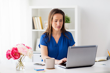 Image showing happy woman with laptop working at home or office
