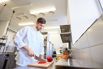 Image showing happy male chef cooking food at restaurant kitchen