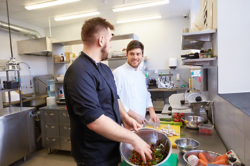 Image showing chef and cook cooking food at restaurant kitchen