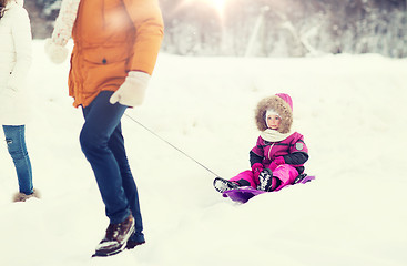 Image showing happy family with sled walking in winter forest