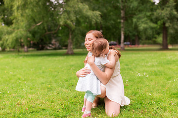 Image showing happy mother hugging baby girl at summer park