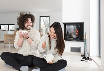 Image showing happy multiethnic couple  in front of fireplace