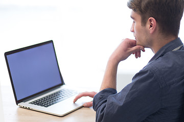 Image showing businessman working using a laptop in startup office