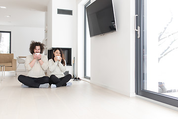 Image showing happy multiethnic couple  in front of fireplace