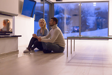 Image showing happy couple in front of fireplace