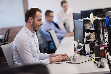 Image showing businessman working using a laptop in startup office