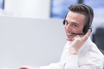 Image showing male call centre operator doing his job