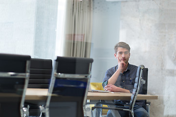 Image showing Young casual businessman using smartphone