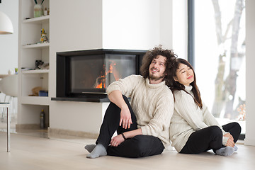 Image showing happy multiethnic couple  in front of fireplace