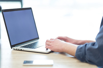 Image showing businessman working using a laptop in startup office