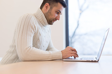 Image showing businessman working using a laptop in startup office