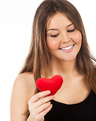 Image showing young woman in love with a heart in hand