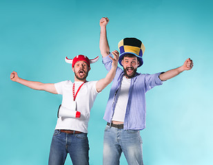 Image showing Two Excited Male Friends Celebrate Watching Sports