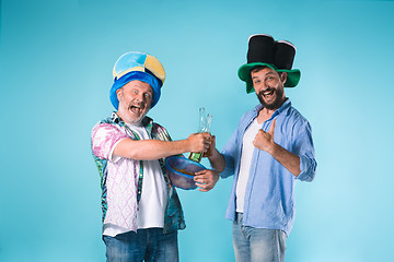 Image showing The two football fans over blue