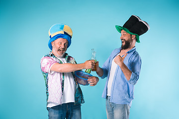 Image showing The two football fans over blue