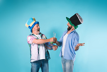 Image showing The two football fans over blue