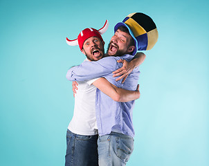 Image showing Two Excited Male Friends Celebrate Watching Sports