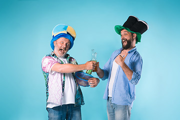 Image showing The two football fans over blue