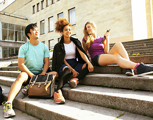 Image showing cute group of teenages at the building of university with books 