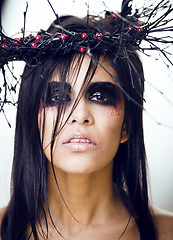 Image showing pretty brunette woman with make up like demon at halloween, clos