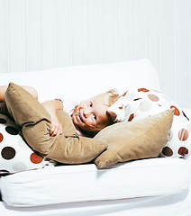 Image showing little cute blonde girl playing at home with pillows