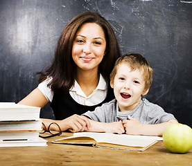 Image showing little cute boy with teacher in classroom