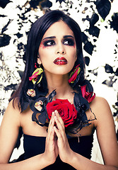 Image showing pretty brunette woman with rose jewelry, black and red, bright m