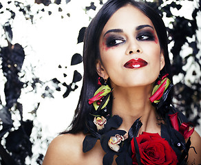 Image showing pretty brunette woman with rose jewelry, black and red, bright m