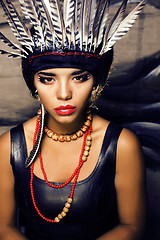 Image showing young pretty woman with make up like red indian, futher in hair,