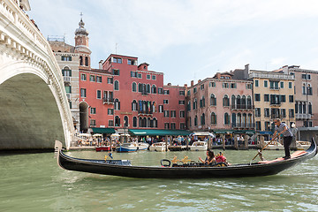 Image showing Famous Ponte di Rialto with traditional gondola passing in Venice, Italy